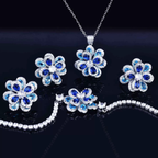 Conjunto de joyas de piedras preciosas variadas con flor de camelia