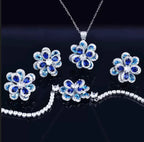 Conjunto de joyas de piedras preciosas variadas con flor de camelia