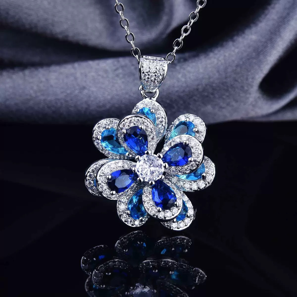 Conjunto de joyas de piedras preciosas variadas con flor de camelia